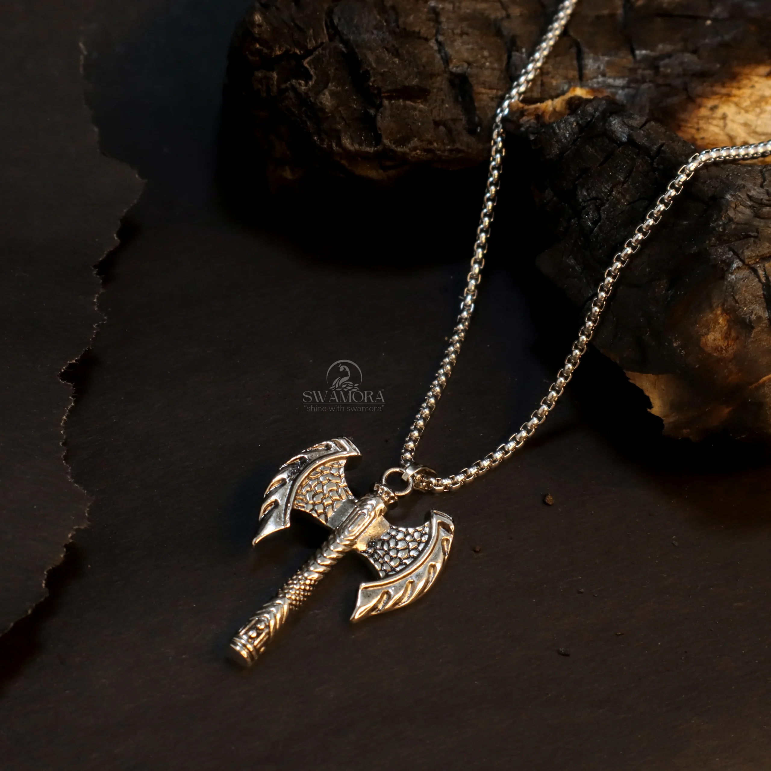 Introducing a powerful and eye-catching necklace for men! This necklace features a uniquely designed Viking axe pendant. The intricate detailing on the pendant and its sturdy construction give it a distinct and impactful look. This necklace is made from high-quality metal and is both stylish and durable. Key Features ⦁ Anti-tarnish The high-quality metal ensures this necklace resists tarnishing and maintains its shine. ⦁ Skin-friendly This material is safe for your skin. ⦁ Long-lasting The sturdy construction and good finish mean this necklace can be worn for a long time. ⦁ The unique Viking axe design gives it a masculine and bold look. ⦁ A great fashion accessory and style statement for men. Give your personality a powerful and unique edge by wearing this specially designed necklace!